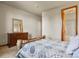 Bedroom with a dresser and a log bed frame with a quilt at 6297 Ellingwood Point Way, Castle Rock, CO 80108