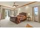 Main bedroom with a king-size bed, fireplace, and access to a balcony at 6297 Ellingwood Point Way, Castle Rock, CO 80108