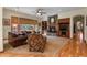 Gathering room with stone fireplace, built-in shelving, and hardwood floors at 6297 Ellingwood Point Way, Castle Rock, CO 80108