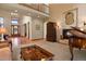 Living room features hardwood floors, a large window, and a grand piano at 6297 Ellingwood Point Way, Castle Rock, CO 80108