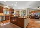 Open concept kitchen with large island, hardwood floors, and ample cabinet space at 6297 Ellingwood Point Way, Castle Rock, CO 80108