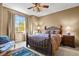 Cozy bedroom with a queen-size bed and large window at 6297 Ellingwood Point Way, Castle Rock, CO 80108