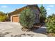 House exterior showcasing a stone facade and wooden garage door at 6297 Ellingwood Point Way, Castle Rock, CO 80108