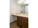 Bathroom with brown vanity and large mirror above the sink at 7900 W Layton Ave # 833, Littleton, CO 80123