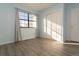 Light blue bedroom with wood-look floors and a large window at 7900 W Layton Ave # 833, Littleton, CO 80123