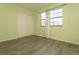 Light green bedroom with wood-look floors and a window at 7900 W Layton Ave # 833, Littleton, CO 80123