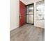 The entryway features light wood flooring and a red door with a security screen at 7900 W Layton Ave # 833, Littleton, CO 80123