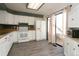 Bright kitchen with white cabinets, wood countertops, and modern appliances at 7900 W Layton Ave # 833, Littleton, CO 80123
