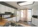 Kitchen with white cabinets, wood countertops and a sliding door leading to a patio at 7900 W Layton Ave # 833, Littleton, CO 80123