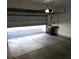 Garage interior with open door and concrete floor at 2121 S Troy Way, Aurora, CO 80014