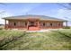 Ranch style home with a covered porch and red door at 39553 County Road 21, Elizabeth, CO 80107