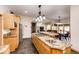 Open kitchen features granite island, breakfast bar, and dining area at 39553 County Road 21, Elizabeth, CO 80107