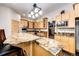 Kitchen features granite countertops and an island with seating at 39553 County Road 21, Elizabeth, CO 80107