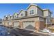 Townhouse exterior showcasing multiple units with attached garages at 1851 S Buchanan Cir, Aurora, CO 80018