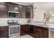 Modern kitchen with stainless steel appliances and ample cabinetry at 1851 S Buchanan Cir, Aurora, CO 80018