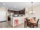 Modern kitchen with dark cabinets, stainless steel appliances, and island at 1851 S Buchanan Cir, Aurora, CO 80018