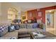 Spacious living room with sectional sofa, hardwood floors, and access to other rooms at 9448 E Florida Ave # 1078, Denver, CO 80247