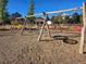 Wooden swing set and play area with wood chips at 9448 E Florida Ave # 1078, Denver, CO 80247