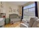 Bright Bedroom with crib, armchair, and large window at 9448 E Florida Ave # 1078, Denver, CO 80247
