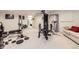 Spacious basement with home gym setup and comfy seating at 12946 Kearney St, Thornton, CO 80602