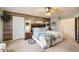 Main bedroom with wood-like accent wall and ceiling fan at 12946 Kearney St, Thornton, CO 80602