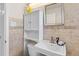 Bathroom with a pedestal sink, toilet, and white cabinet at 530 Dover St, Lakewood, CO 80226