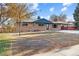 Brick ranch home with a well-maintained lawn and mature tree at 530 Dover St, Lakewood, CO 80226