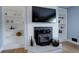 White brick fireplace with built-in shelving on either side at 530 Dover St, Lakewood, CO 80226