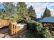 Relaxing hot tub area with wooden steps and surrounding landscaping at 27425 Spruce Ln, Evergreen, CO 80439