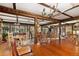 Spacious dining room features hardwood floors, exposed beams, and multiple seating areas at 27425 Spruce Ln, Evergreen, CO 80439