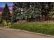 Exterior of charming lodge-style home nestled in a wooded area at 27425 Spruce Ln, Evergreen, CO 80439