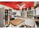 Bright kitchen boasts white cabinetry, wood countertops, and a red ceiling at 27425 Spruce Ln, Evergreen, CO 80439
