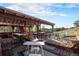 Spacious backyard patio with multiple seating areas and mountain views at 27425 Spruce Ln, Evergreen, CO 80439