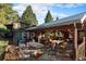 Spacious patio with multiple seating areas and a covered pavilion at 27425 Spruce Ln, Evergreen, CO 80439