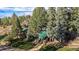 Exterior view of charming home with landscaping and mountain backdrop at 27425 Spruce Ln, Evergreen, CO 80439