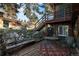 Rustic patio with a charming table and chairs, nestled in the woods at 27425 Spruce Ln, Evergreen, CO 80439