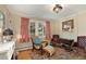 Cozy living room with fireplace, comfortable seating, and large windows at 27425 Spruce Ln, Evergreen, CO 80439