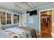 Cozy bedroom with a light blue color scheme, a comfortable bed, and plenty of windows at 27425 Spruce Ln, Evergreen, CO 80439