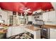 Modern kitchen features white cabinets, wood countertops, and stainless steel appliances at 27425 Spruce Ln, Evergreen, CO 80439