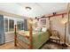 Inviting bedroom with a four-poster bed and wood floors at 27425 Spruce Ln, Evergreen, CO 80439
