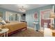 Bright bedroom with a floral-patterned bedspread and ensuite bathroom at 27425 Spruce Ln, Evergreen, CO 80439