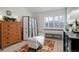 Bright bedroom with wood dresser and room darkening curtains at 10279 W Fair Ave # E, Littleton, CO 80127