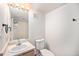 Clean bathroom with a toilet, sink, and shower at 1646 S Deframe St # A1, Lakewood, CO 80228