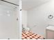 Bathroom with shower, toilet and patterned floor at 1646 S Deframe St # A1, Lakewood, CO 80228