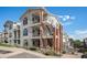 Two-story townhouse exterior, featuring brick accents and balconies at 1646 S Deframe St # A1, Lakewood, CO 80228