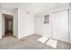 Bedroom with carpet flooring, double closets and access to hallway at 1646 S Deframe St # A1, Lakewood, CO 80228