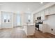 Modern kitchen with white cabinets, island, and stainless steel appliances at 2875 Taryn St, Erie, CO 80026