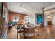 Dining area with wood table and chairs, exposed brick walls, and hardwood floors at 2261 Blake St # 1H, Denver, CO 80205