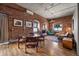 Living room with exposed brick walls, hardwood floors, and a comfortable seating area at 2261 Blake St # 1H, Denver, CO 80205