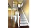 Grand staircase with dark wood railing, leading to upper level at 6962 W Chatfield Dr, Littleton, CO 80128